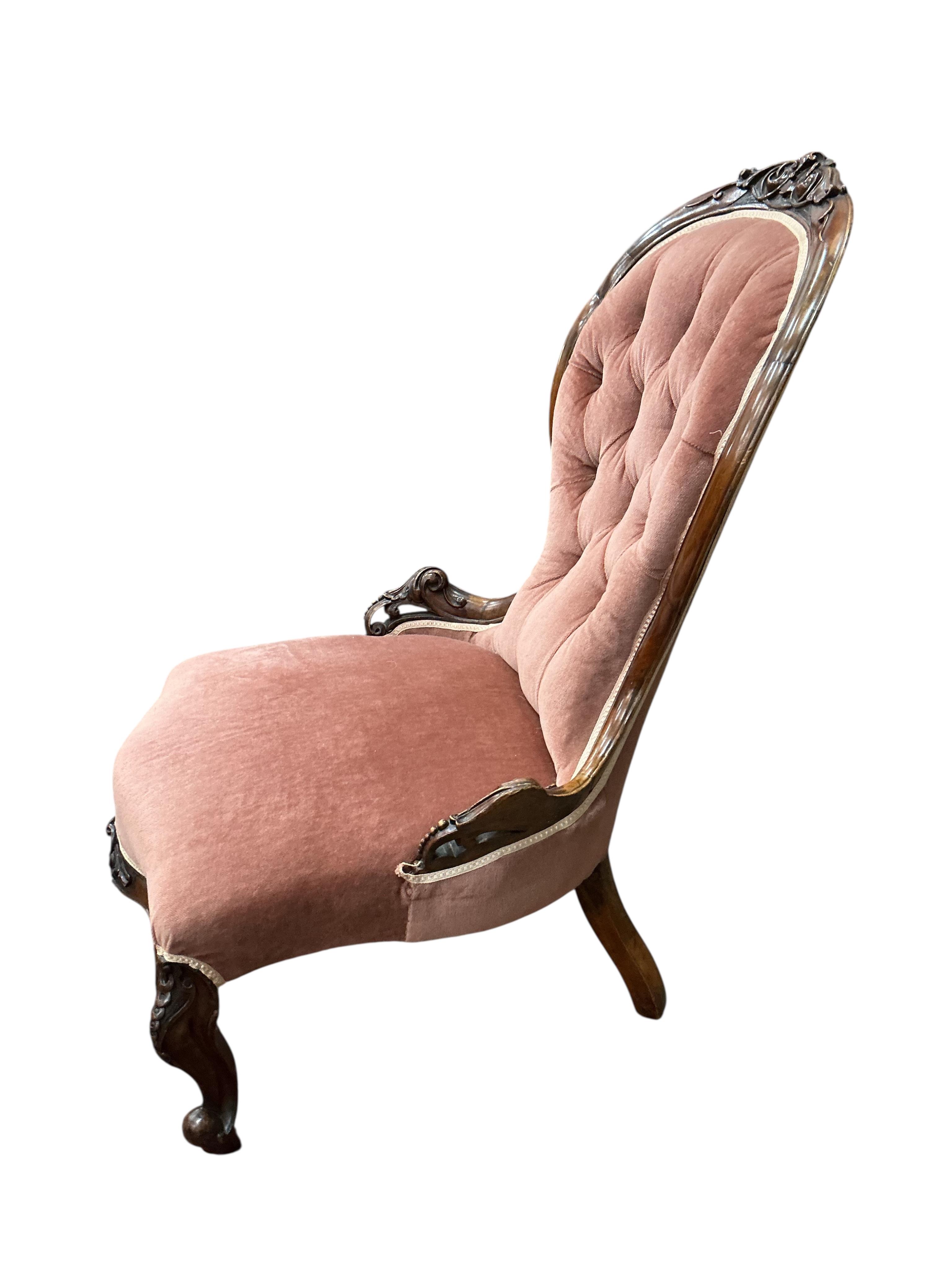 A Victorian mahogany spoon back nursing chair and a circular footstool, diameter 60cm